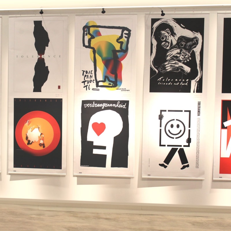 Photograph of the display of posters for the Tolerance Project, including the artist's work "Friends Not Food," at the Tolerance Poster Show in Beirut