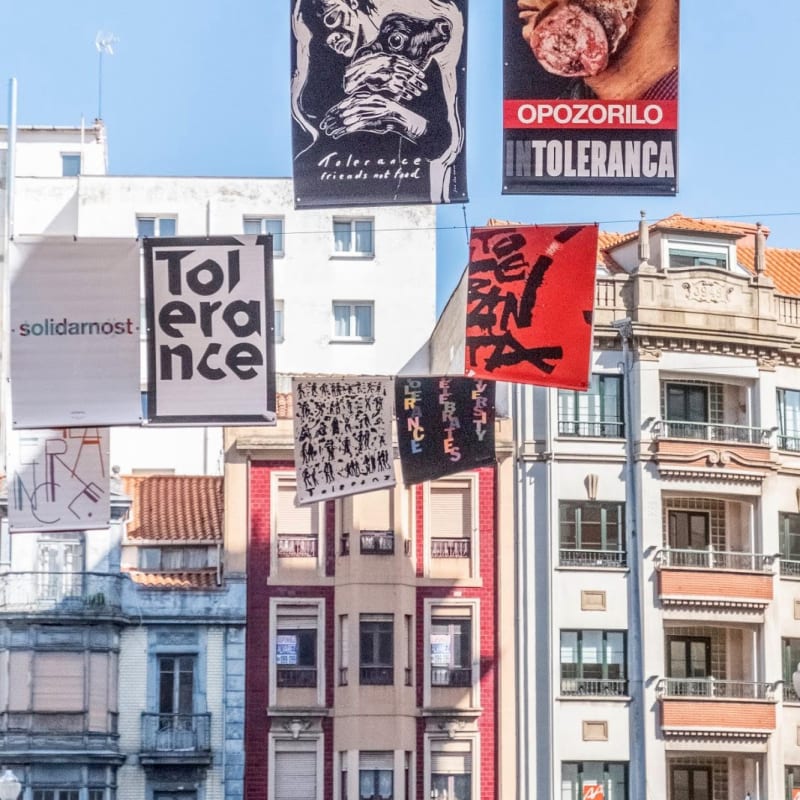 Exhibition installation hung high above the streets in Portugal, including the artist's work "Friends Not Food"