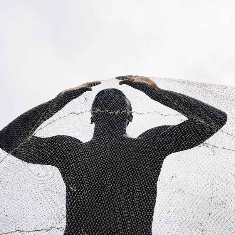 Photograph by Ghanaian Nana Yaw Oduro presenting a behind a fishnet