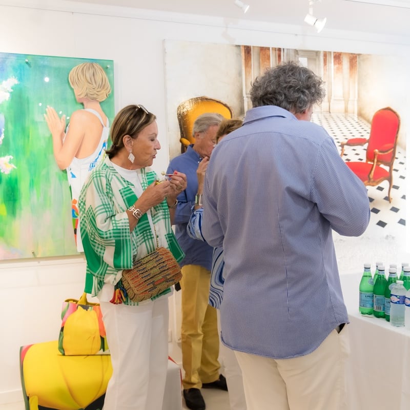 People inside of Carousel Fine Art's gallery space in Saint Tropez.