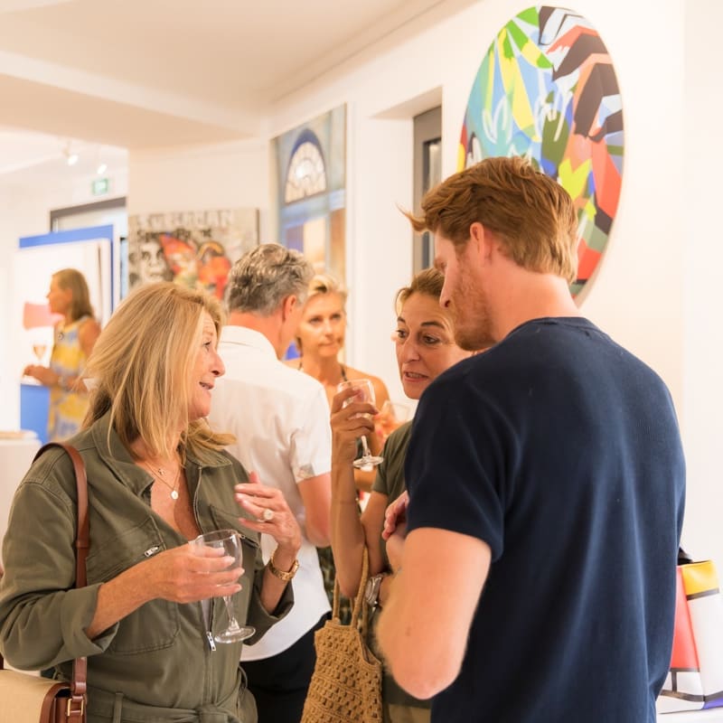 People inside of Carousel Fine Art's gallery space in Saint Tropez.