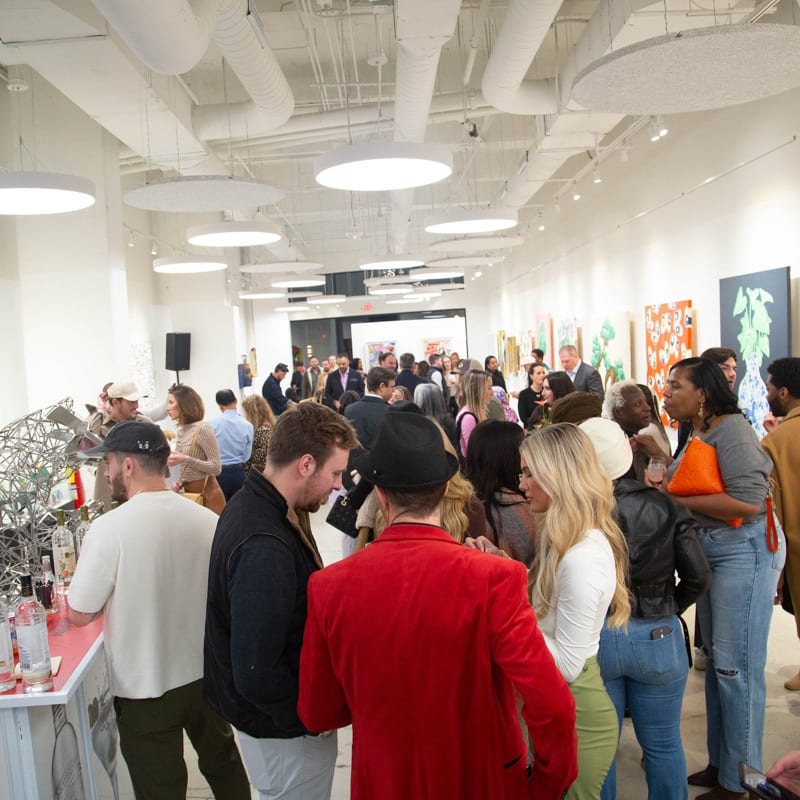 People in Carousel Fine Art's Atlanta gallery space during the spotlight exhibition for John Westbay titled "Love, Outside the Lines."