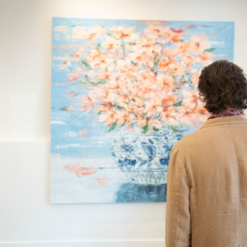 Man staring at painting by Eric Alfaro displayed in Carousel Fine Art's Buckhead Village location during the exhibition "Spring Reverie."