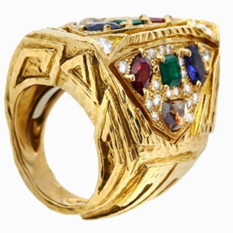 RING, DAVID WEBB, USA, MID-SIXTIES MATERIAL: Yellow gold, sapphires, rubies, emeralds and diamonds fancy DESCRIPTION: sculpture ring made of beat...