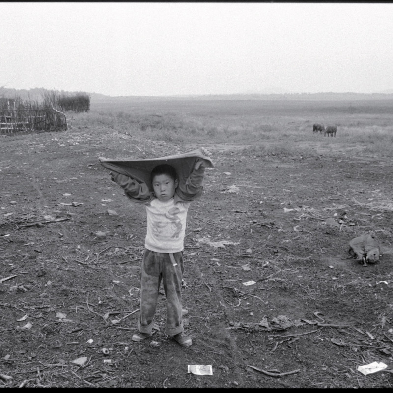 《遮雨的男孩，河北》 Boy Sheiding Himself from the Rain, Hebei 1997