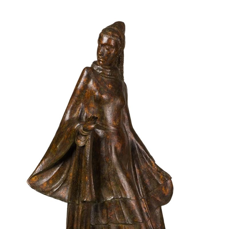 Bronze figure of a woman in a long flowing dress