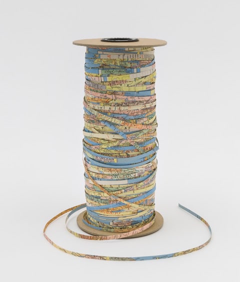 Viviane Rombaldi Seppey At the Beginning, 2018 cardboard, hand cut world map 8 inches x 4 inches diameter