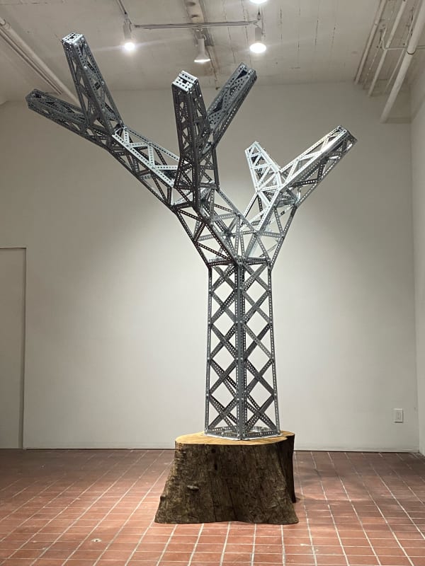 Roman de Salvo Electric Picnic Redux, 2021 zinc-plated steel slotted angle and perforated strap hardware, oak log 117 x 86 x 72 in 297.2 x 218.4 x 182.9 cm