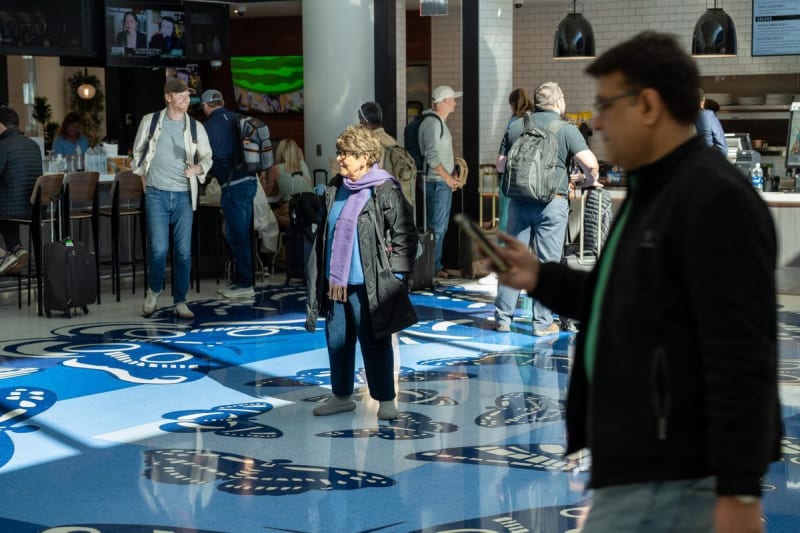 Regina Silveira stands in the middle of her masterpiece at Bush Airport.