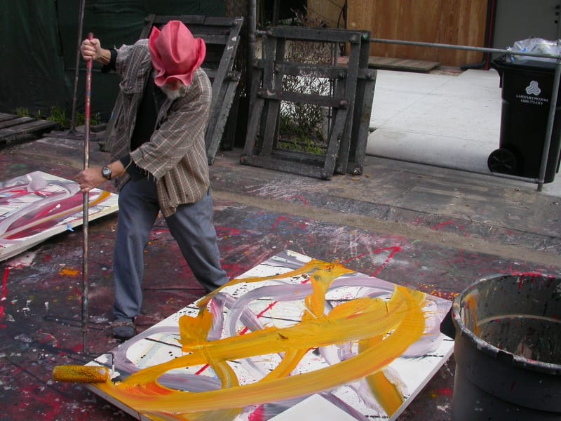 Image shows artist Ed Moses in the process of painting