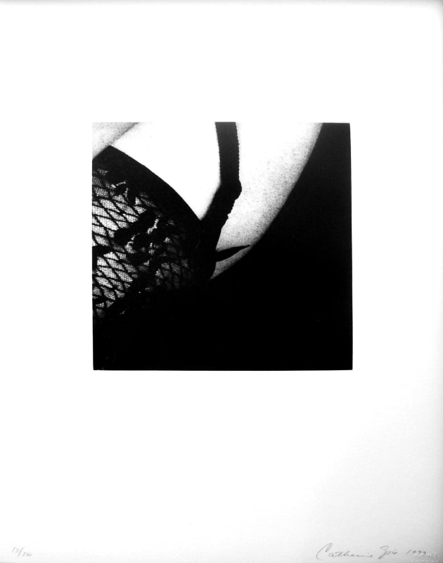 Black and white closeup image of a person's garter belt and tights 