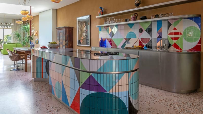 Artist Claudia Wieser’s geometric murals decorate the vibrant kitchen. Photo: Anne-Catherine Scoffoni