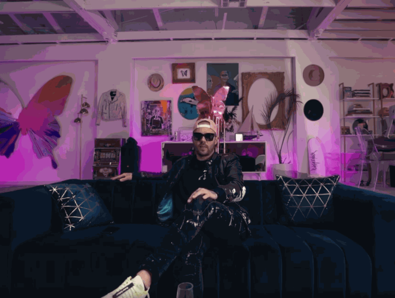 Artist PunkMeTender sitting on a couch