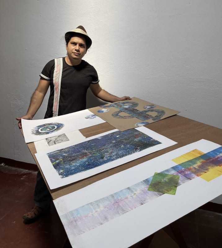 Noel Omar Saavedra shows some of his prints