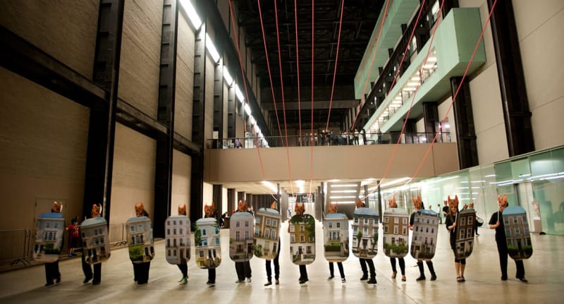 Performance still of Hew Locke, Give and Take, 2014, As part of BMW Tate Live: Up Hill Down Hall-An Indoor Carnival, Tate Modern, London