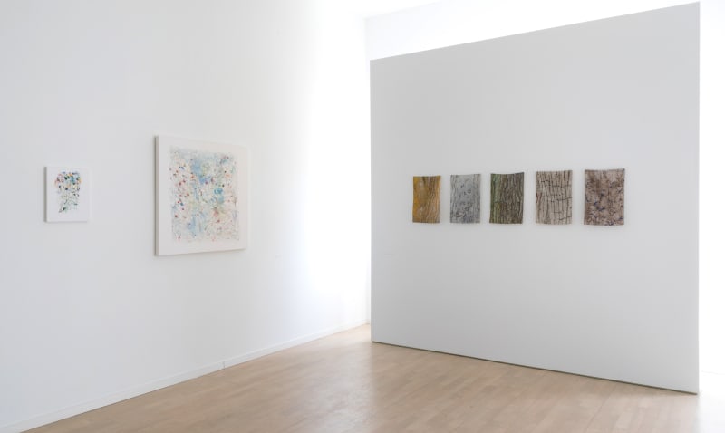 Two Robert Harms paintings on the left, and five Laurie Lambrecht Bark Cloths on the right.