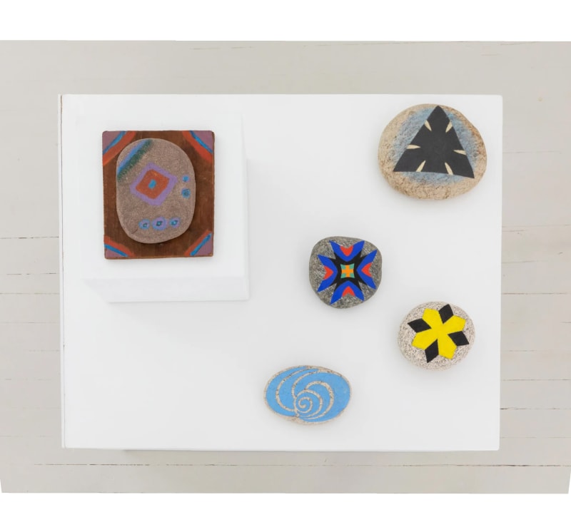 A group of five painted rocks, four by Jack Youngerman, and the largest one on a small plinth by Betty Parsons.
