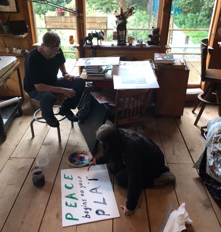 Photograph of the artist and Steve Murray painting protest signs to bring to an animal rights march, September 2018.