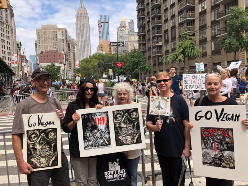 Photograph of the artist and her friends holding protest signs at the "Defend Animals March," September 2018