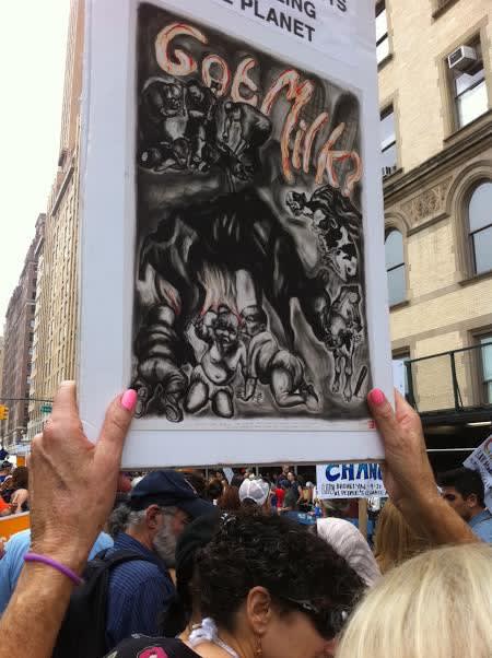 Photograph of a protester holding up an image of Coe's "Got Milk?" during an animal rights march, September 22, 2014