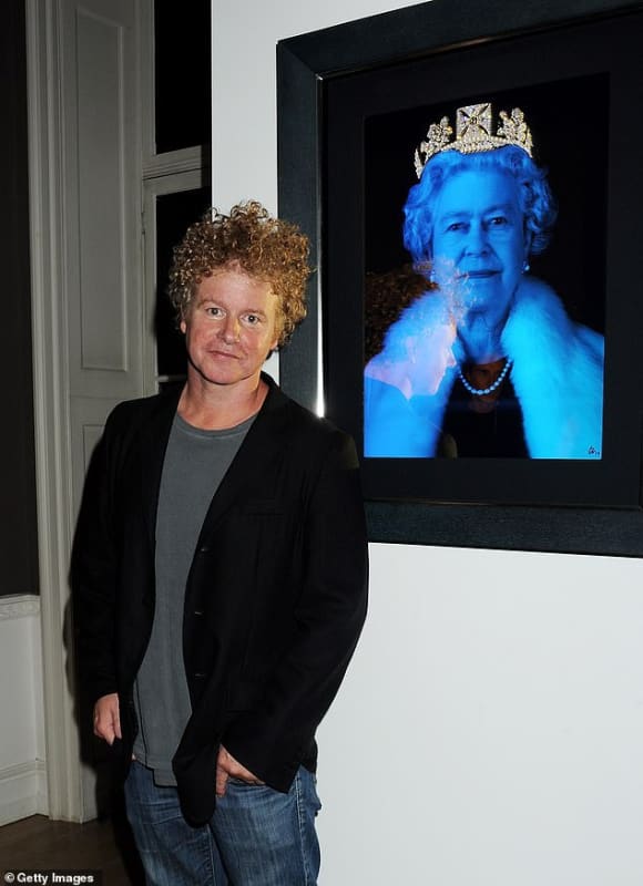 Artist Chris Levine standing next to his artwork featuring a holographic portrait of a woman wearing a crown and fur, displayed in a black frame.