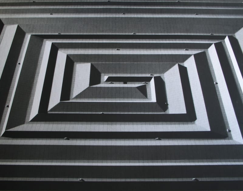 Black and white photomontage of a three dimensional structure in the form of a rectangular spiral