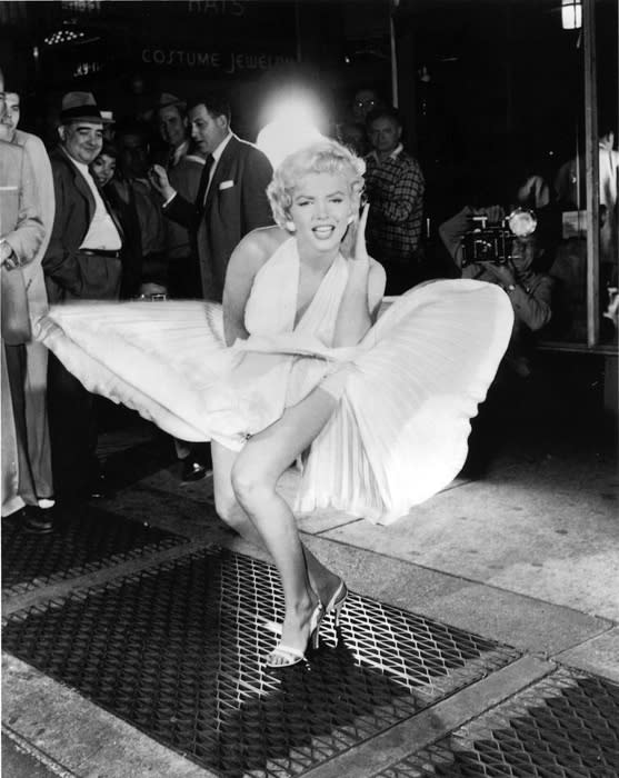 Marilyn Monroe wearing a white dress in the famous photograph over a subway grate, skirt floating