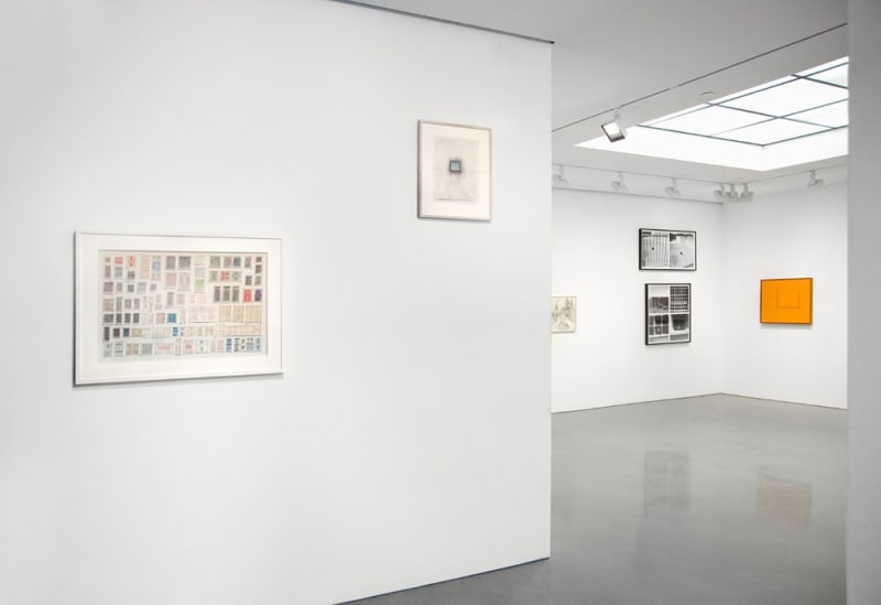 Gallery installation view of abstract paintings, photograph of building