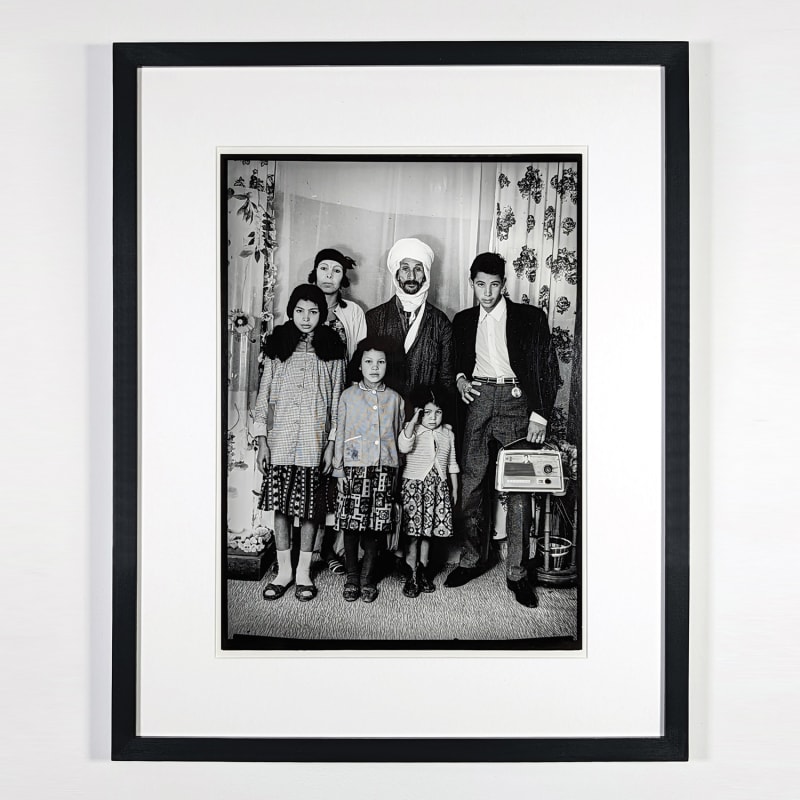Black and white photograph of an Algerian family posing in a photo studio in Ain Beida, Algeria