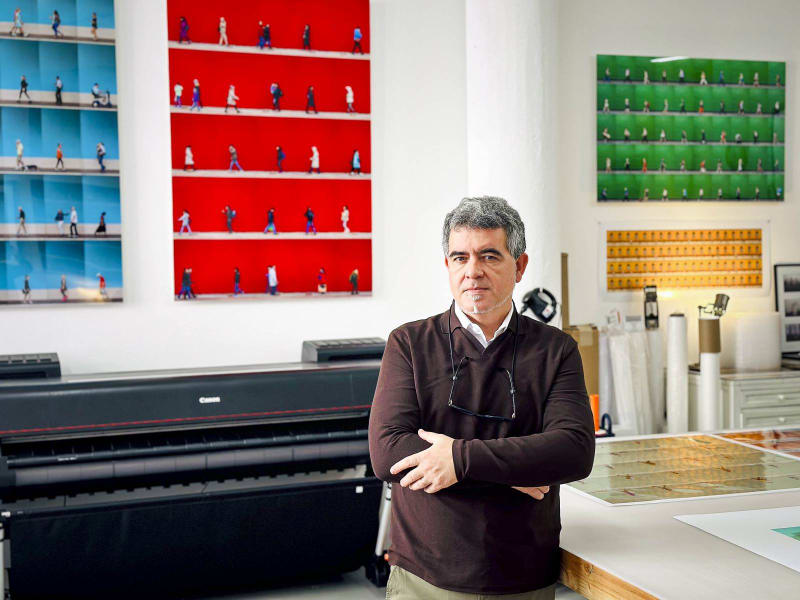 Spanish artist and photographer Xan Pardón posing in front of his "Time Lapse" series.