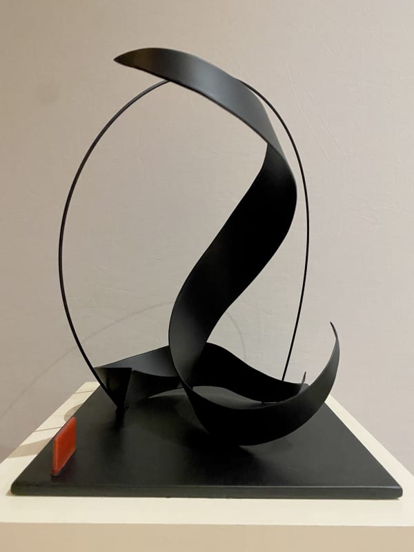 black painted steel sculpture with wave