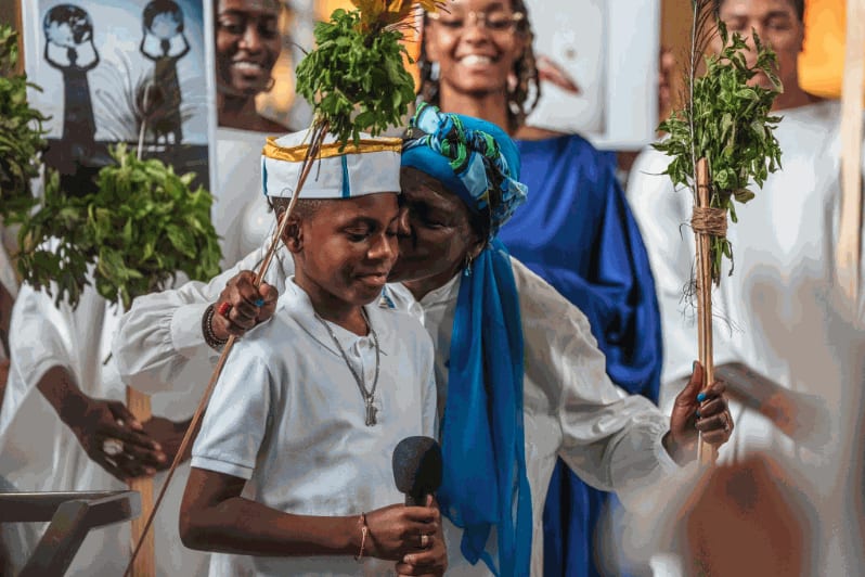 Kayden Hern, a 10-year-old poet, performs a reading on the steps of El Museo del Barrio on Fifth Avenue, the final stop for the procession. Credit: Graham Dickie/The New York Times
