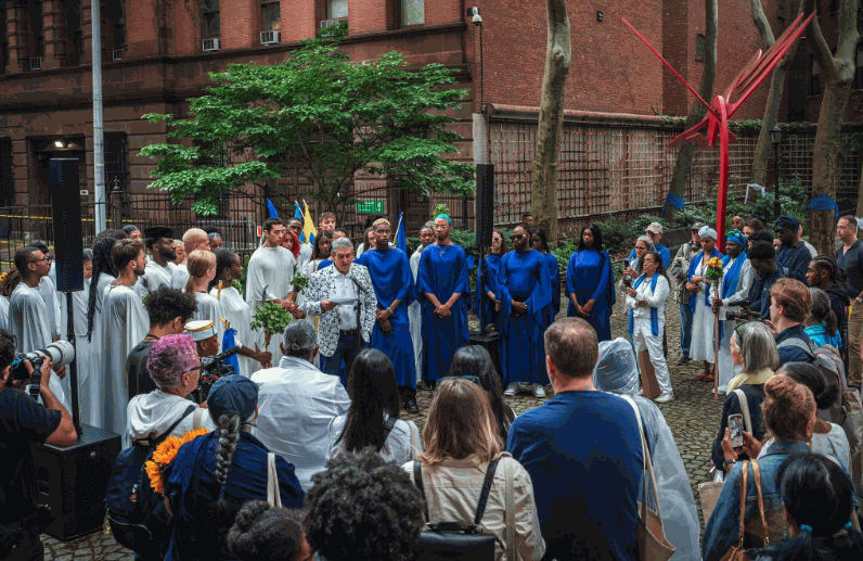 The poet Richard Blanco does a reading at Harlem Art Park on 120th Street before the start of the procession. Credit: Graham Dickie/The New York Times