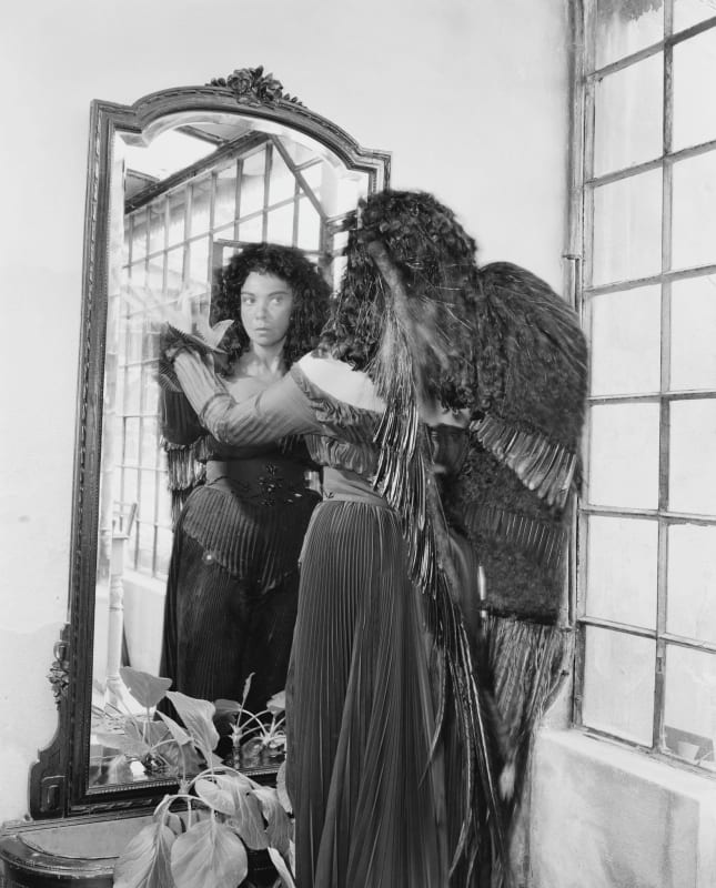 Leonor Fini dressing as a fantastical creature in front of her mirror. The female Surrealist painter usually depicts women in situation of power and imaginary character in her paintings.