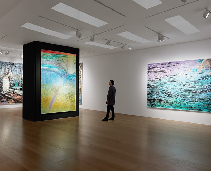 A man looking at a large scale painting by Ena Swansea in a gallery with wood floors and white walls