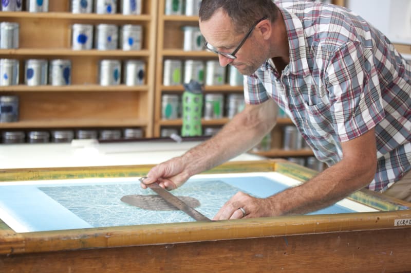 Emil Lukas examining a screen for print edition
