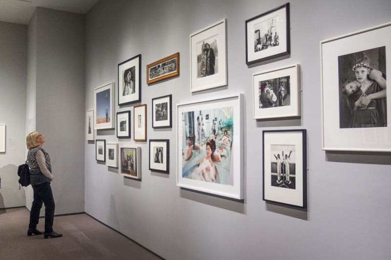 Diane Arbus Sally Mann Abelardo Morell Dorothea Lange Harry Callahan included at the Museum of Fine Arts Boston, visitor to MFA Boston museum viewing photographs on museum wall