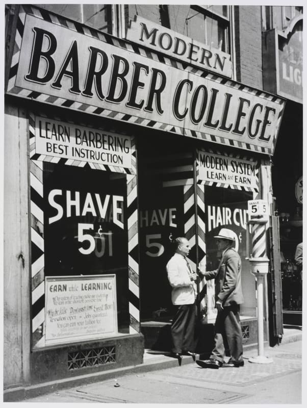 photograph of barber shop with Shave 5 cents sign and men in doorway