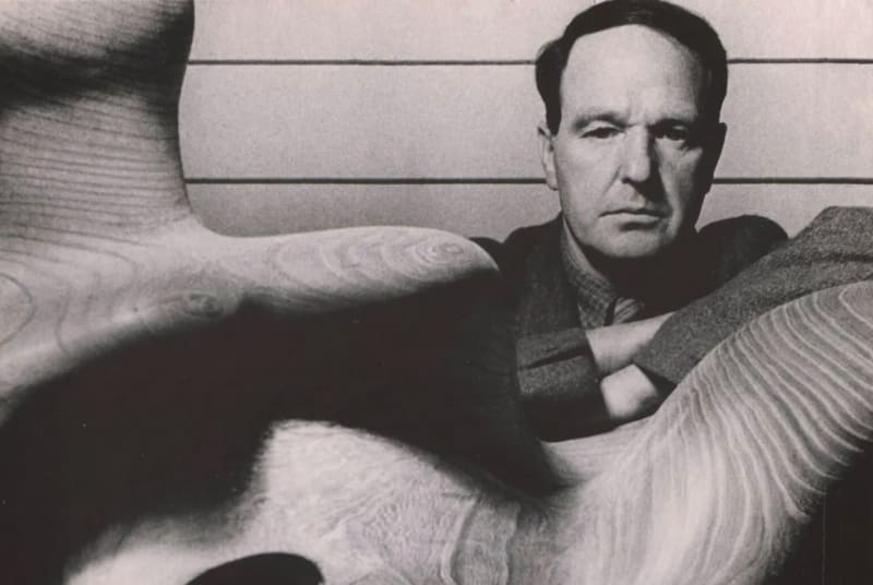 photograph of Henry Moore with detail of sculpture