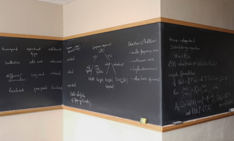 Formulas on chalkboard by mathematician David Damanik of Rice University wrapping around three walls, by Jessica Wynne from the Do Not Erase series