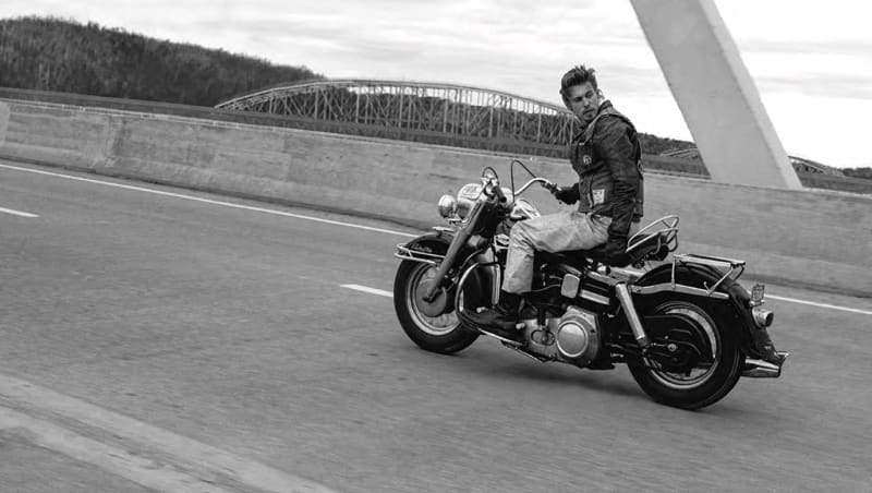 Austin Butler writing a motorcycle in film still reminiscent of Danny Lyon's Crossing the Ohio photograph