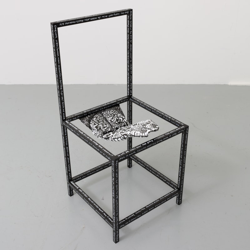 Chair with a tongue sticking out of the seat area. Titles of works written all around the wooden frame.