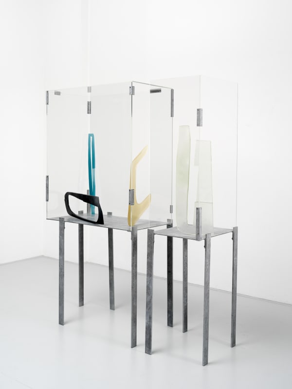 sculptures encased in a clear table by Nairy Baghramian