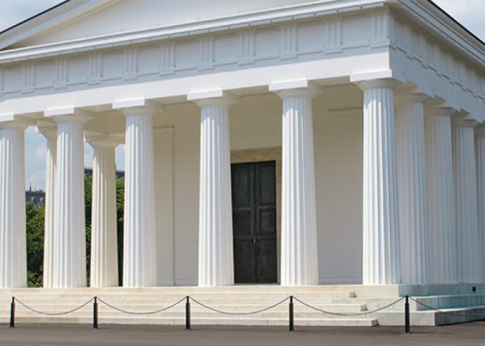 Roped off white temple with greek columns.