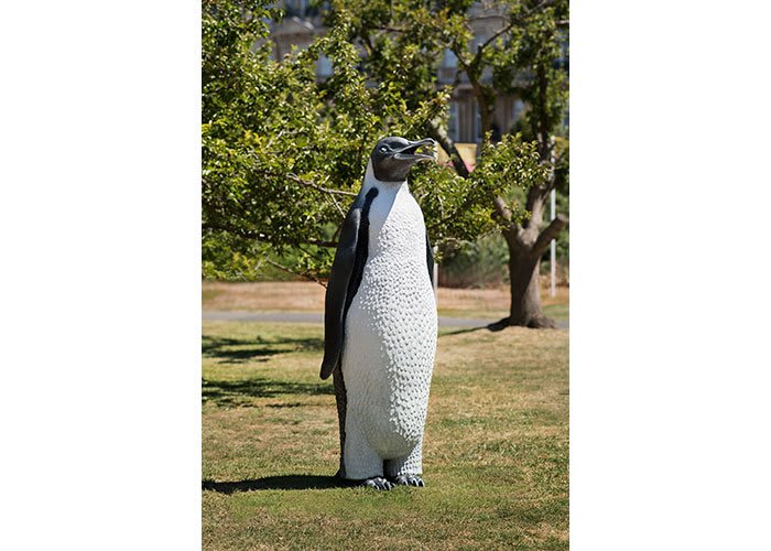 textured penguin sculpture on grass