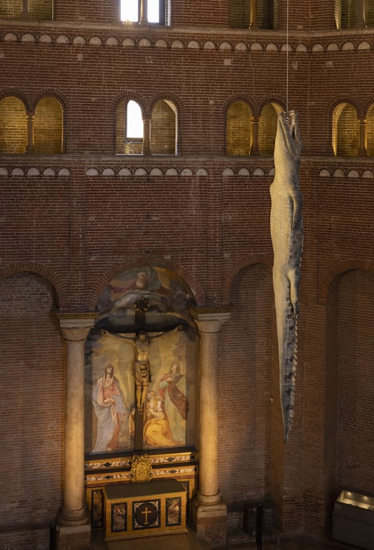 A genuine crocodile, hanging lifelessly by its neck