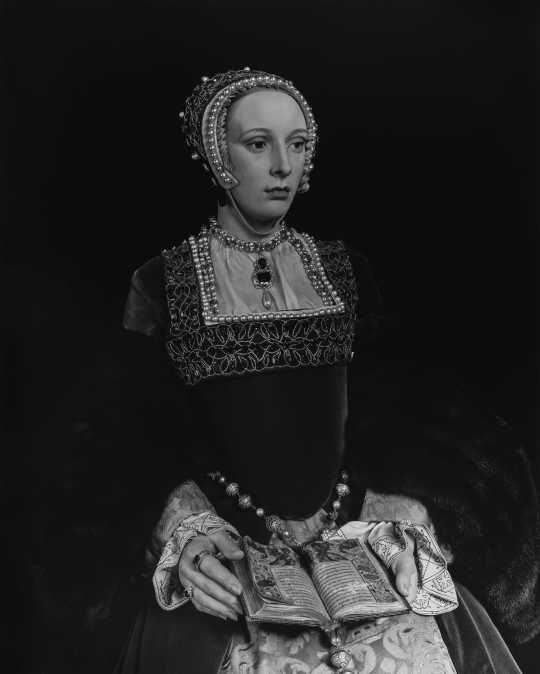 Black and white image of wax figure of Catherine Howard seated.