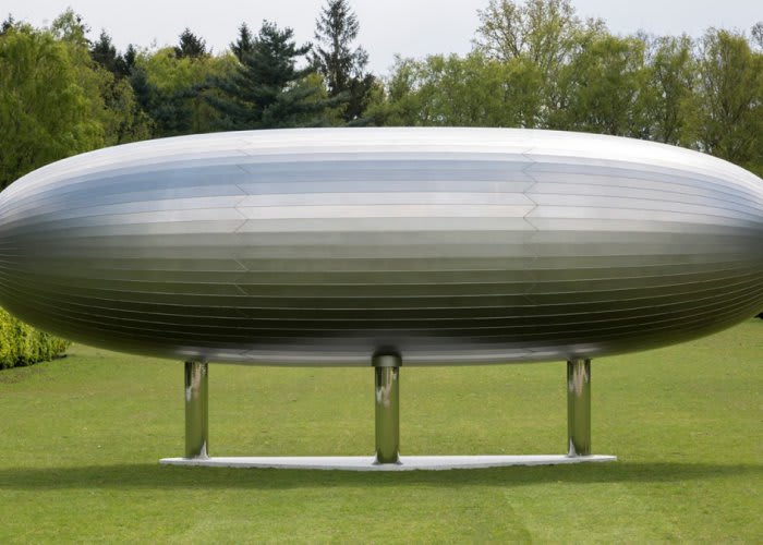 metal cylinder on three legs installed on a lawn.