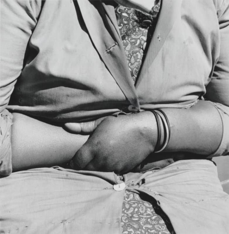 A close up of a woman's clothed torso; photograph by David Goldblatt