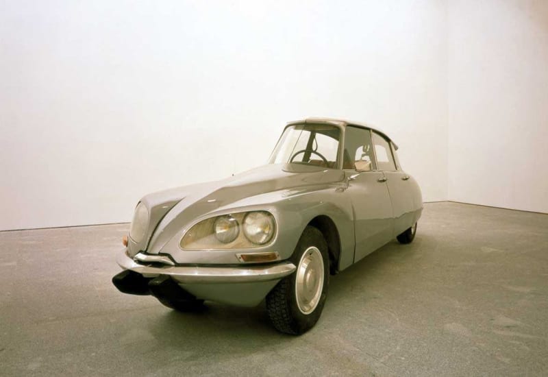 Gallery view of thin light green car with only one seat.